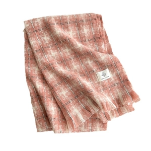 Soft pink and white plaid cashmere scarf with woven texture and premium brand label