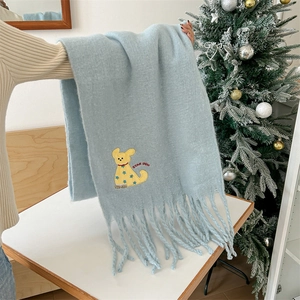 Light blue mohair scarf with cartoon dog embroidery and fringes in festive setting