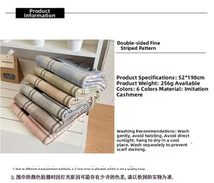 Detail view of double-sided plaid cashmere-like scarf with product specs and material info