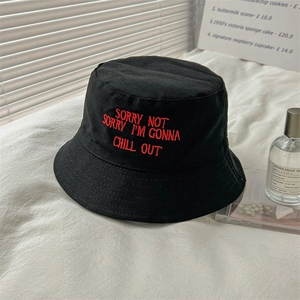 Black cotton bucket hat with red embroidery and stylish chill out typography for sun protection