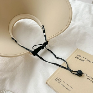 Beige wrap-around sun visor for women with wide brim and adjustable black windproof cord