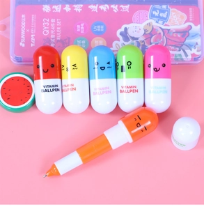 Close-up of colorful retractable capsule pens with cute faces and Vitamin Ballpen text