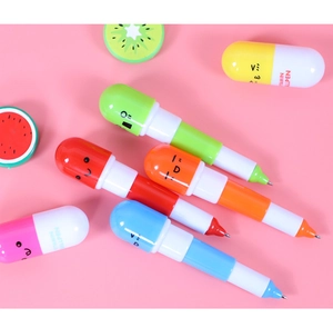 Colorful pill-shaped retractable ballpoint pens with cute faces on pink background