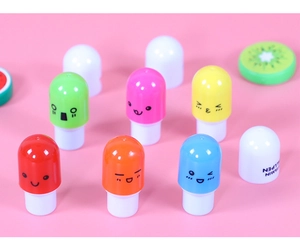 Close-up of colorful capsule-shaped retractable ballpoint pens with cute emoji faces