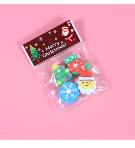 Detailed view of Christmas erasers set in packaging with Santa and tree motifs