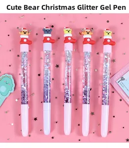 Close-up of pink Christmas quicksand pens with cute bears wearing red holiday hats