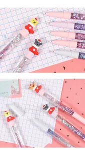 Detail of Christmas themed quicksand pens with glitter liquid and cute 3D cartoon toppers