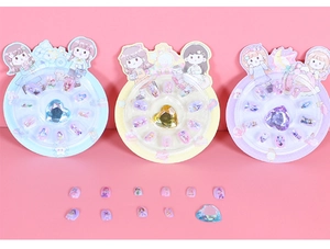 Detailed view of colorful cartoon girl nail stickers with heart-shaped rhinestones