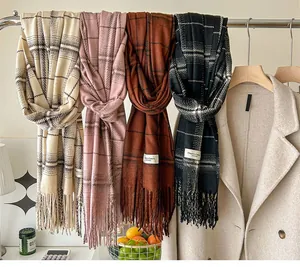 Close-up of elegant plaid scarves with soft fringe details in multiple classic colors