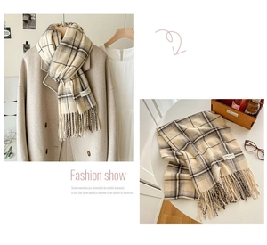 Detailed view of soft cashmere-feel plaid scarf with classic tassels and chic fabric label