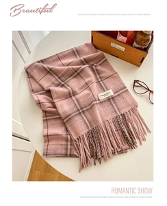 Detail of pink and brown plaid cashmere-like scarf with soft tassels and woven tag