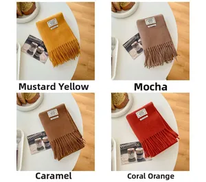 Detail view of winter wool scarves in Mustard Yellow, Mocha, Caramel, and Coral Orange