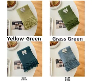 Detail of 100% wool scarves in yellow-green, grass green, dark green and star blue colors