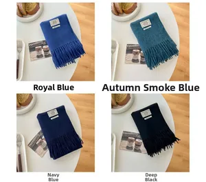 Detail view of 100% wool scarves with fringe edges in royal blue, navy, and black colors