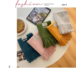 Detailed shot of five colors 100% wool scarves with soft fringe and white fabric labels