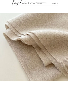 Detailed macro view of soft beige 100% wool scarf showing high-quality woven texture