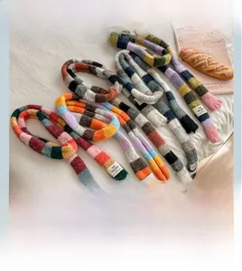 Detailed knit texture and tassels of a colorful rainbow striped winter scarf