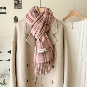 Pink plaid faux cashmere scarf with tassels styled on a wool coat for a winter look