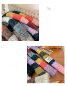 Close-up of rainbow striped knit scarf showing fuzzy mohair texture and colorful panels