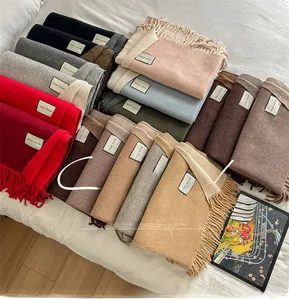 Selection of colorful wool blend scarves with delicate fringe edges and quality labels