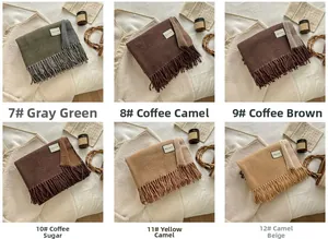 Detail view of thick wool blend scarves with tassels in various earth tone colors