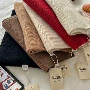 Premium 100% wool knitted scarf in various neutral colors with ribbed texture and soft feel