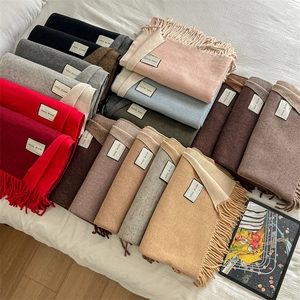 Wool blend thick warm winter scarves with tassels in multiple colors on white fabric