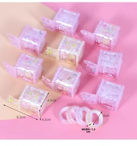 Detail view of cartoon pattern washi tape rolls in a transparent plastic dispenser case
