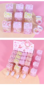 Detailed view of cartoon crystal tape rolls featuring strawberry girl and rabbit patterns