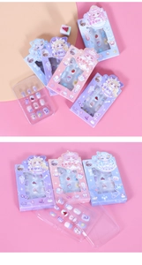 Detail of colorful cartoon press-on nail sets for kids with strawberry and heart patterns
