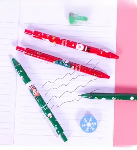 Detail of Christmas retractable gel pens with festive illustrations on a notebook
