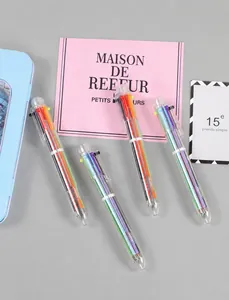 Flat lay view of four transparent multi-color ballpoint pens with six ink refills