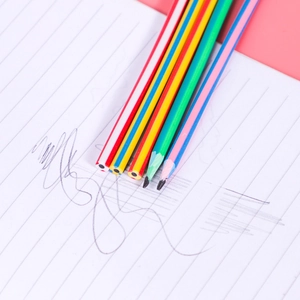 Flexible colorful striped pencils on lined paper with sharpened tips for creative drawing