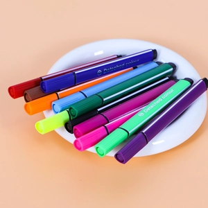 Multicolor triangular watercolor pen set with vibrant nibs on white ceramic plate