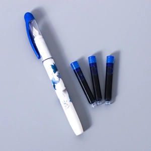 Detail of a white fountain pen with blue patterns and three matching ink cartridges