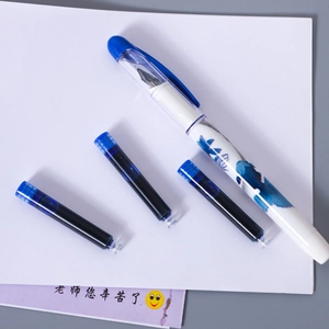 Detail of white fountain pen with blue patterns and three blue ink refills on paper
