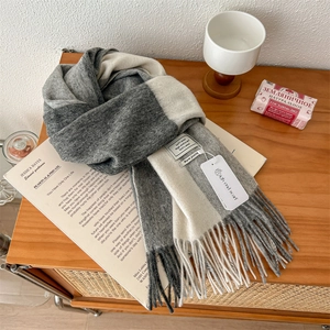 Detailed view of 100% pure wool scarf with tassel fringe and minimalist color blocks