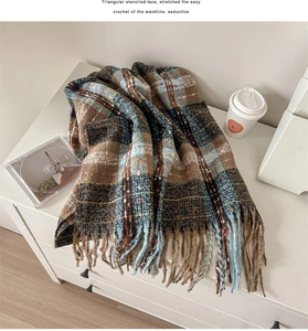 Detail of plaid tassel scarf with soft brown and blue checkered wool blend texture