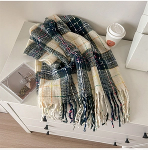 Detail of soft vintage plaid scarf featuring navy blue checks and long fringed tassels