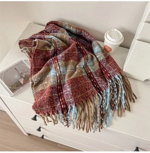 Detail of vintage plaid scarf with red and blue checks and thick fringe tassels