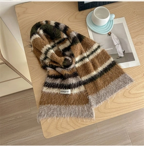 Detailed knit texture of vintage striped wool scarf on a wooden table for winter