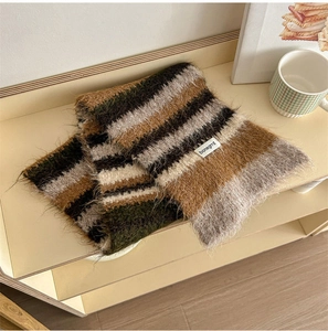 Detail of plush knitted wool scarf showing fuzzy texture and colorful striped pattern