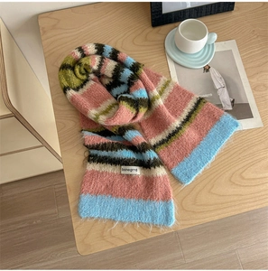 Detailed macro view of striped mohair scarf with soft texture and brand textile label