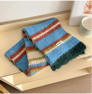 Close-up of fluffy striped knit wool scarf showing soft texture and cozy colorful fringe