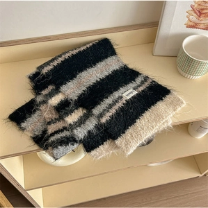 Close-up of soft striped knit wool scarf with premium texture and bonegrid brand label