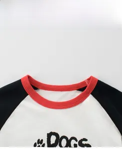 Detail showing red ribbed neckline and 'Dogs' printed pattern on kids' cotton T-shirt