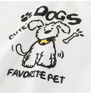 Detailed view of the cute cartoon dog print on a soft white cotton kids T-shirt