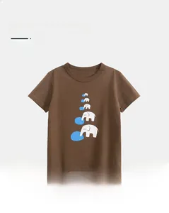 Detail of soft cotton kids t-shirt showing cartoon elephant prints on brown fabric