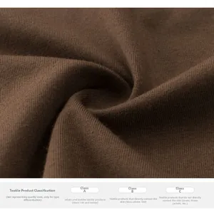 Close-up of brown knitted fabric texture showing premium soft material and safety labels