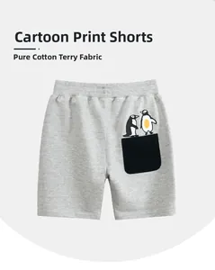 Detail of grey cotton shorts for boys featuring a cute penguin print and a black back pocket